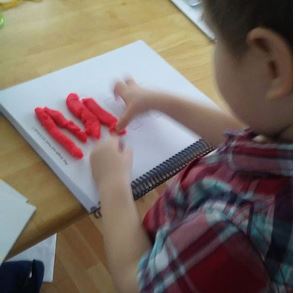 Filling in the letter M/m with Play-Doh.